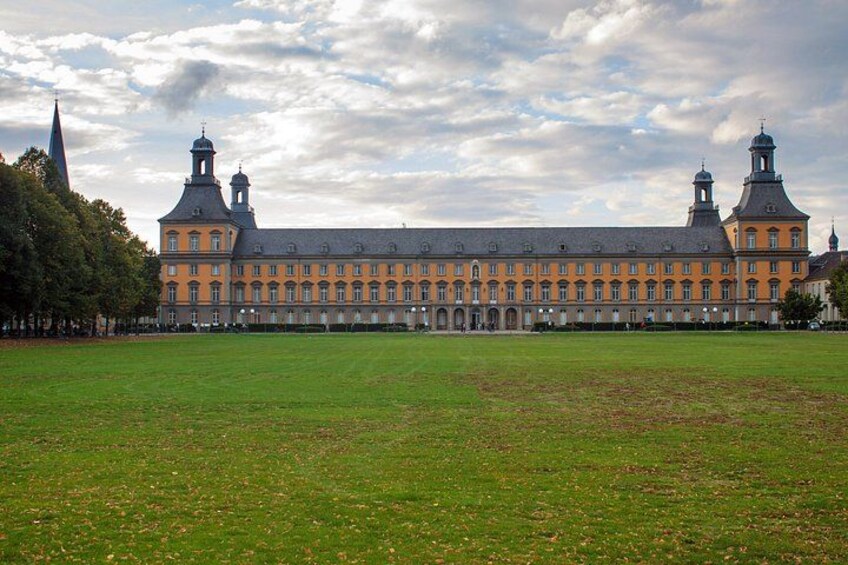 A large historic building with multiple towers and a spacious courtyard. 4
