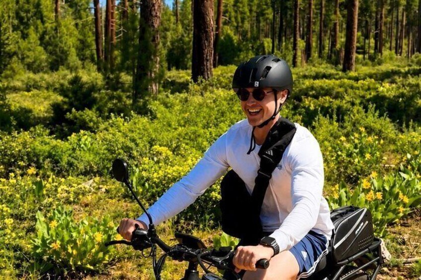A person riding a motorcycle in a forested area. 5