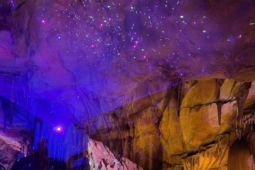 A cave with stalactites and a starry ceiling. 4
