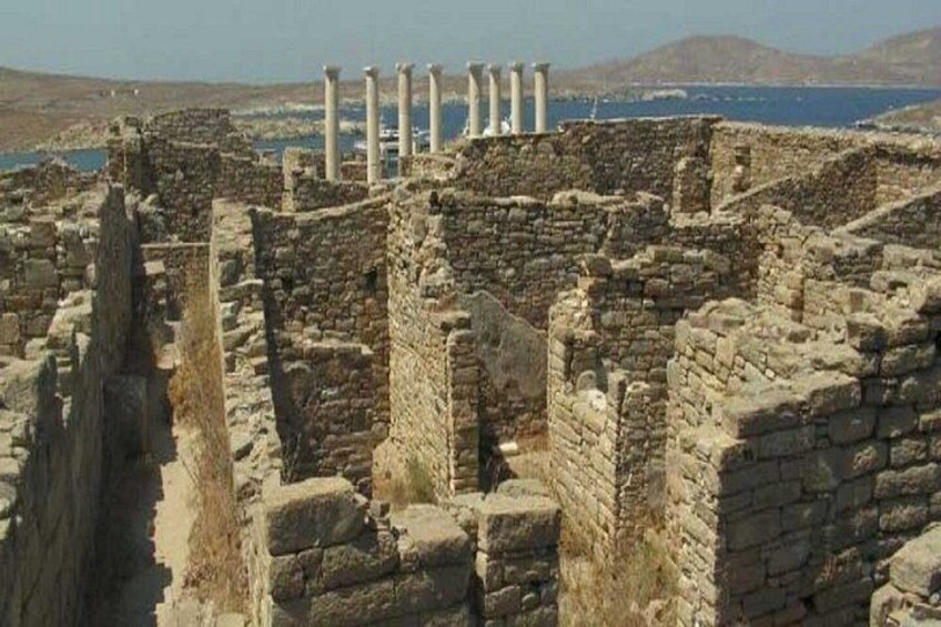 Ancient ruins with columns and a coastal backdrop. 4