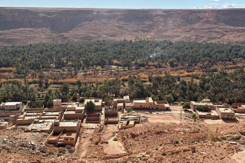 A desert landscape with a small settlement of adobe houses. 3