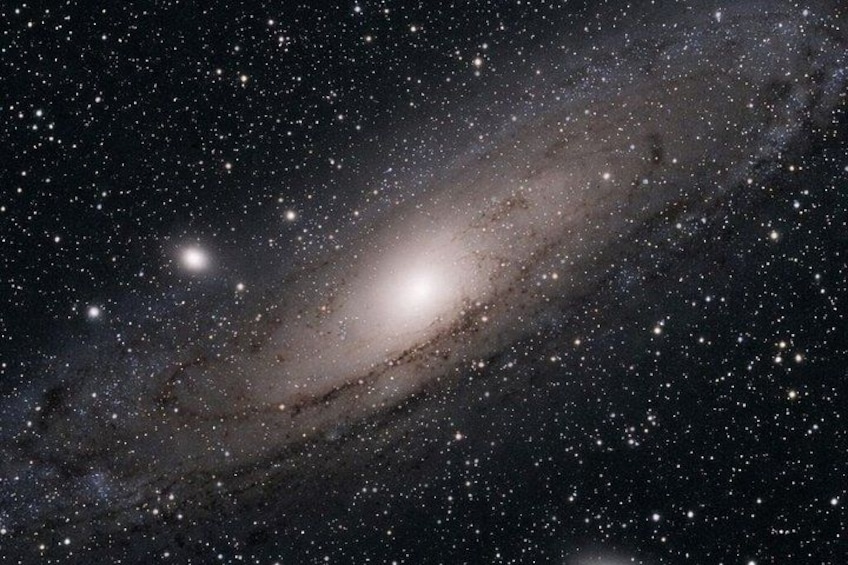 A galaxy with numerous stars and a bright central region. 2