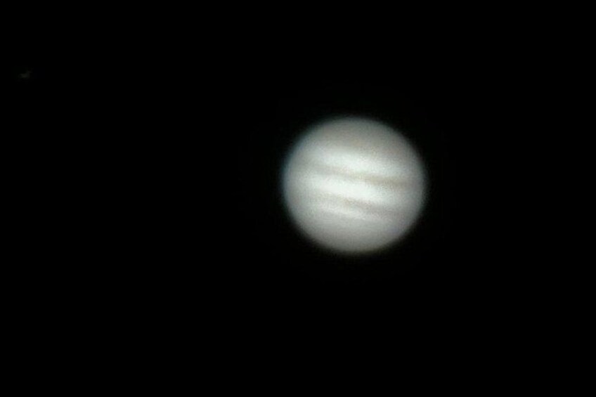 A planet with visible bands and a dark background. 4