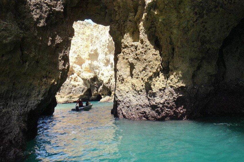 A boat in a narrow waterway between rocky cliffs. 3