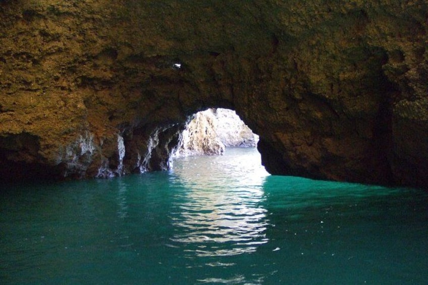 A cave entrance with turquoise water. 4