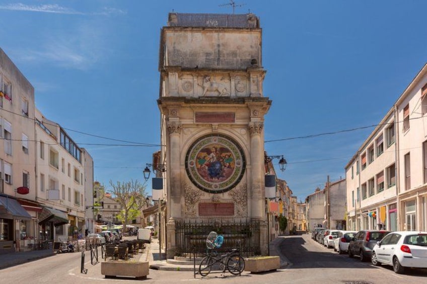A historic clock tower with intricate carvings and a circular stained glass window. 2