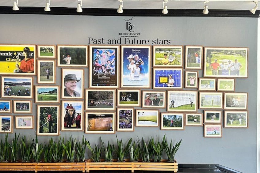 A wall with framed pictures and a sign reading 'Past and Future stars'. 3