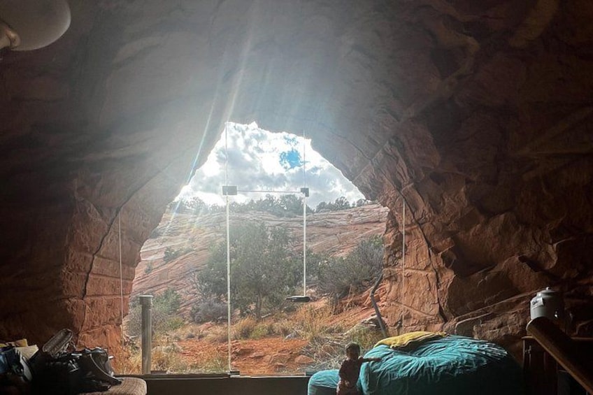A cave with a view of a mountain landscape. 1