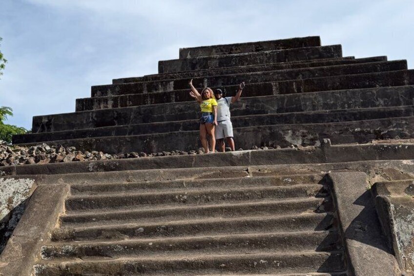 A set of stone steps leading up to a large, ancient pyramid structure. 2