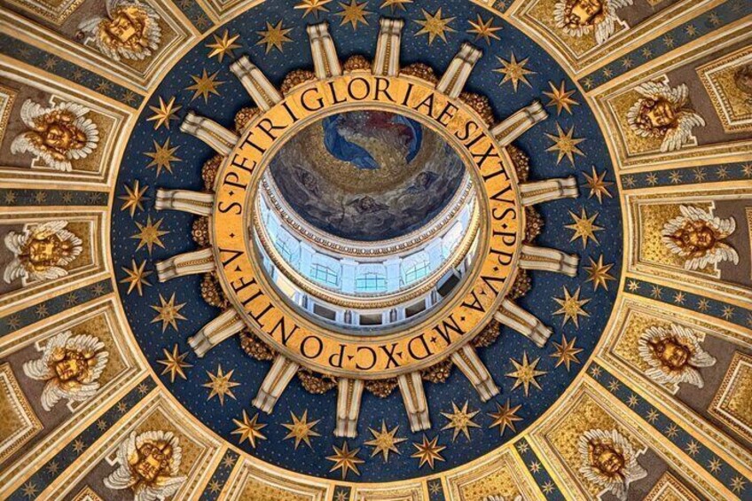 A domed ceiling with intricate gold and blue patterns, stars, and text. 4