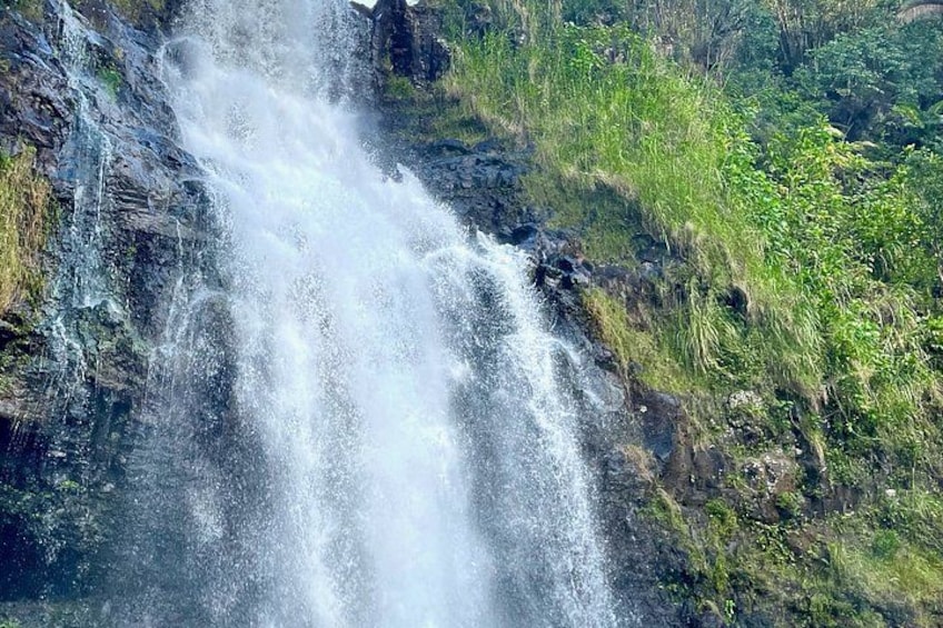 A waterfall cascading over rocks in a natural setting. 2