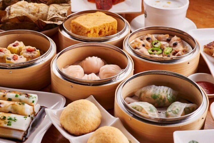 A variety of dim sum dishes in bamboo steamers. 3