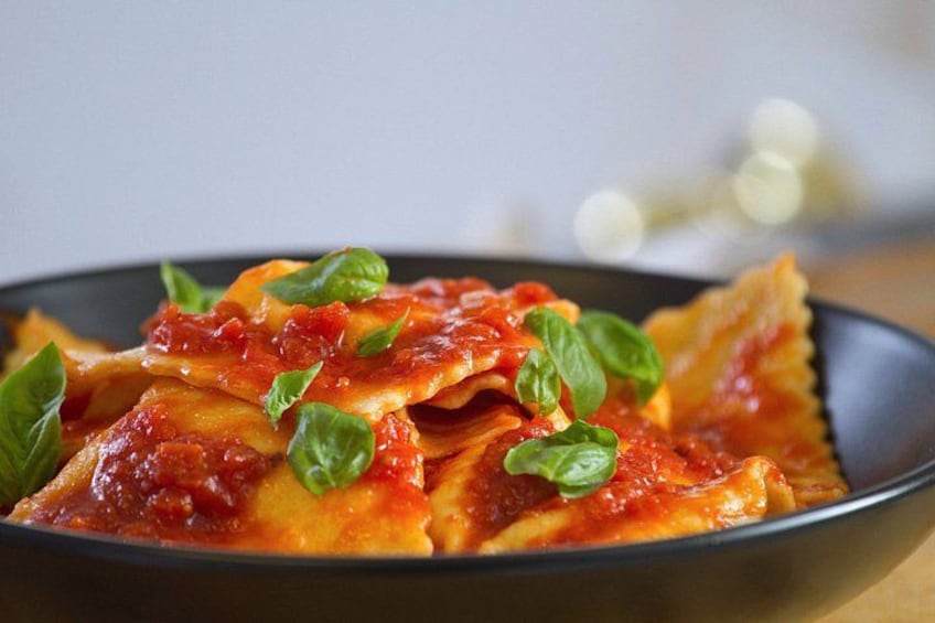 Ravioli with tomato sauce and basil on a plate. 3
