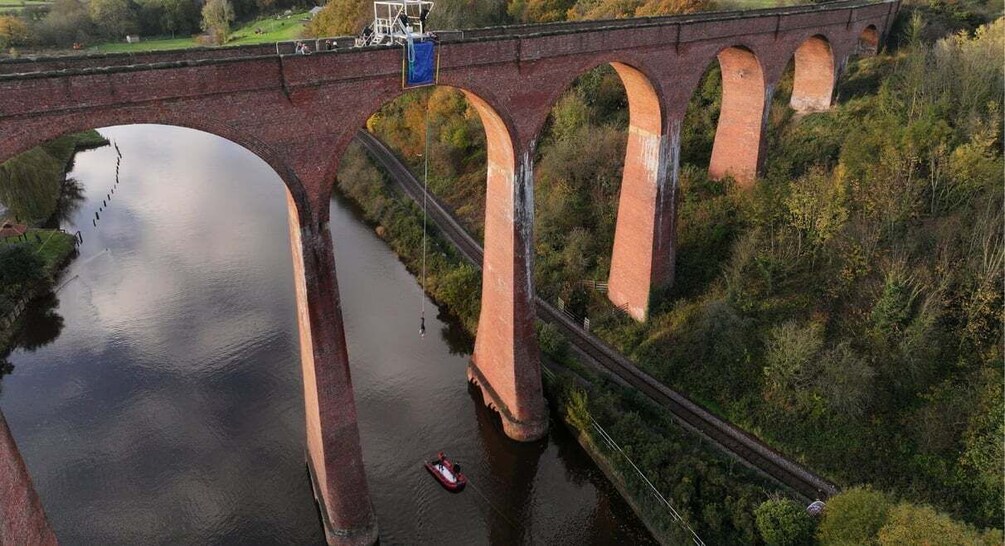 A bridge with multiple arches over a river, surrounded by greenery. 2