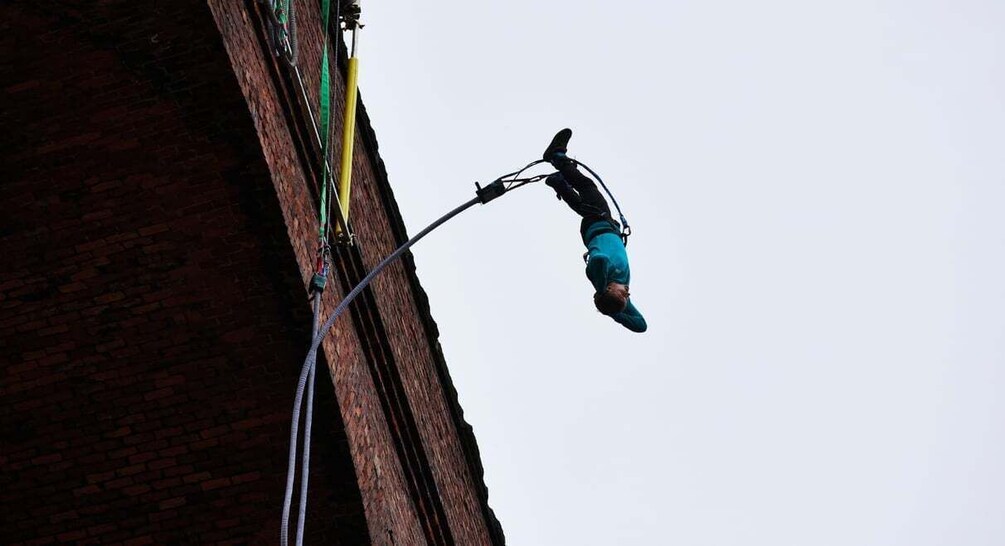 A person bungee jumping from a building. 5