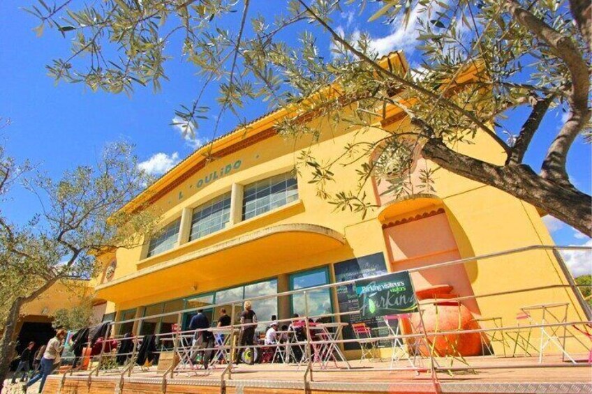 A yellow building with a sign 'La Outina' and a storefront with a sign 'La Outina.' 4