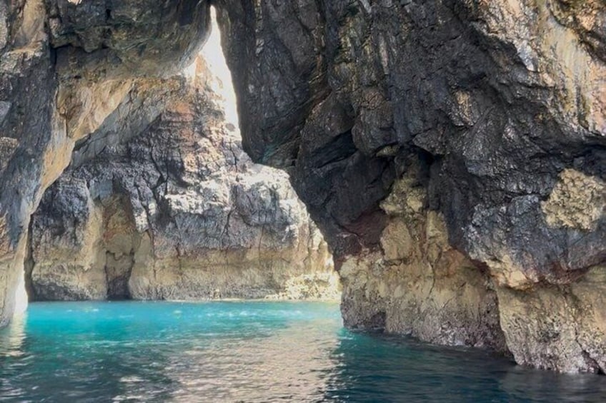 A natural rock formation with a clear blue water body. 4
