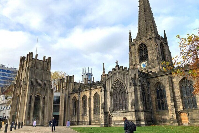 A historic church with a tall spire and large arched windows. 4