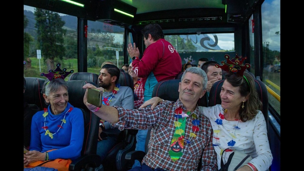 People on a bus with some wearing colorful neck accessories. 3