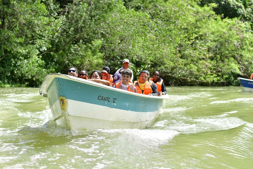 A boat with people wearing life jackets on a river. 3
