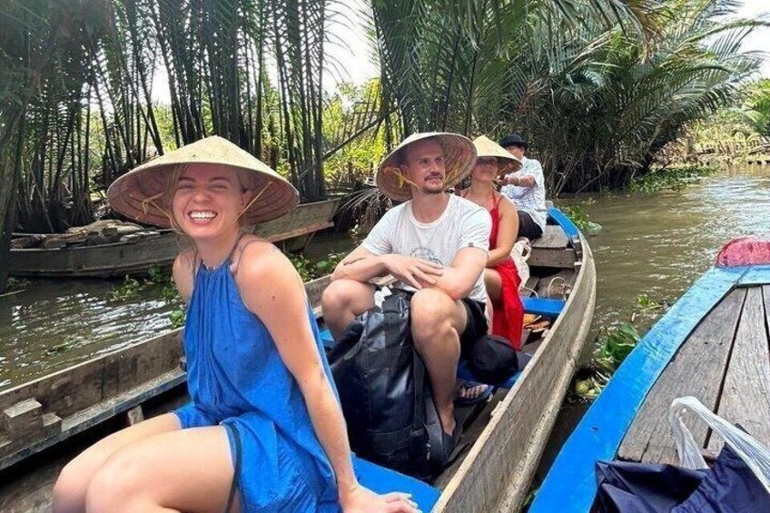 People in a boat on a river surrounded by palm trees. 2