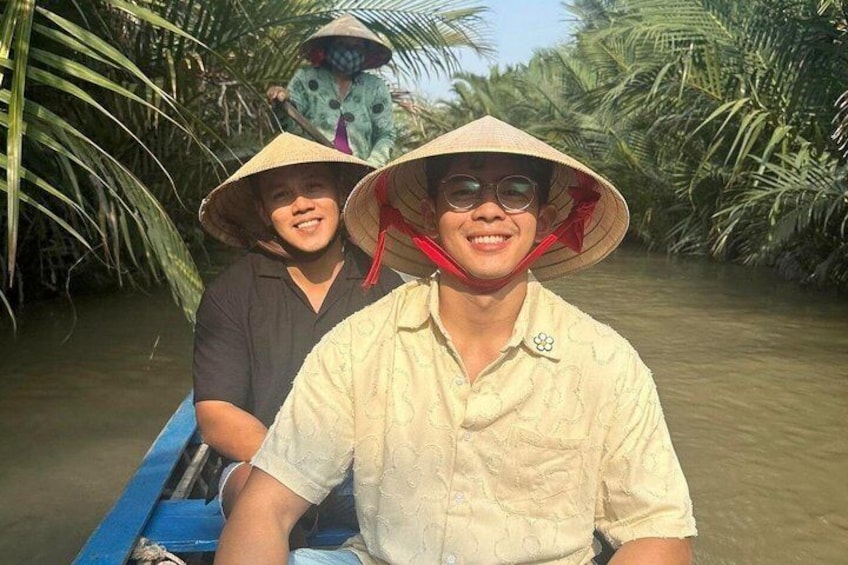 Two people in a boat surrounded by palm trees. 5