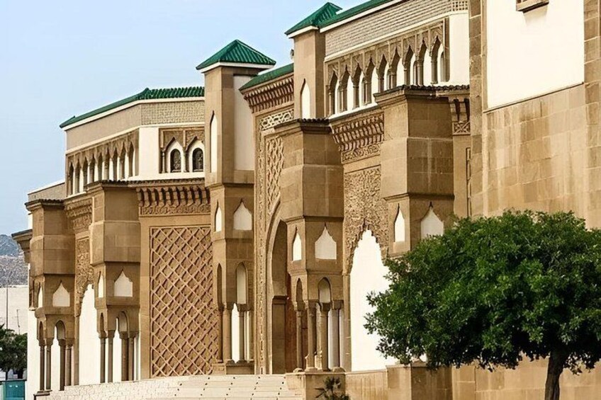 A historic building with arches, columns, and intricate lattice work. 2