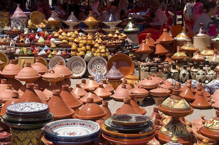 A market with various pottery items, including pots and plates. 5