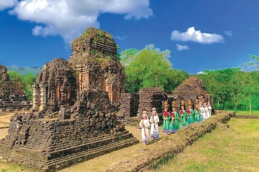 Oude ruïnes met een groep mensen in traditionele kledij. 1