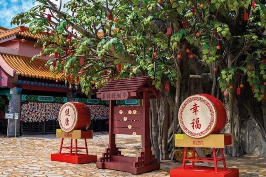 A traditional Chinese temple with red drums and a wooden structure with Chinese characters. 3