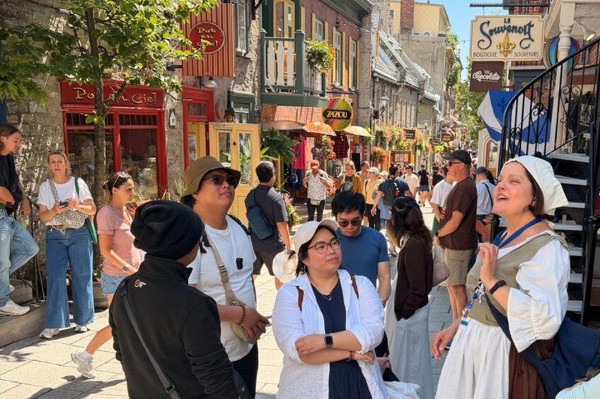 A busy street with people, shops, and a sign for 'Soucierot.' 4