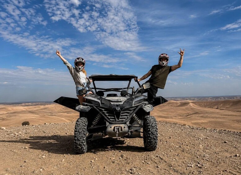 Two people on an ATV in a desert landscape. 3