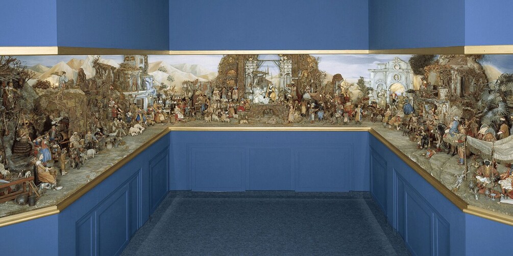 A detailed diorama of a historical scene with figures, buildings, and a landscape. 2