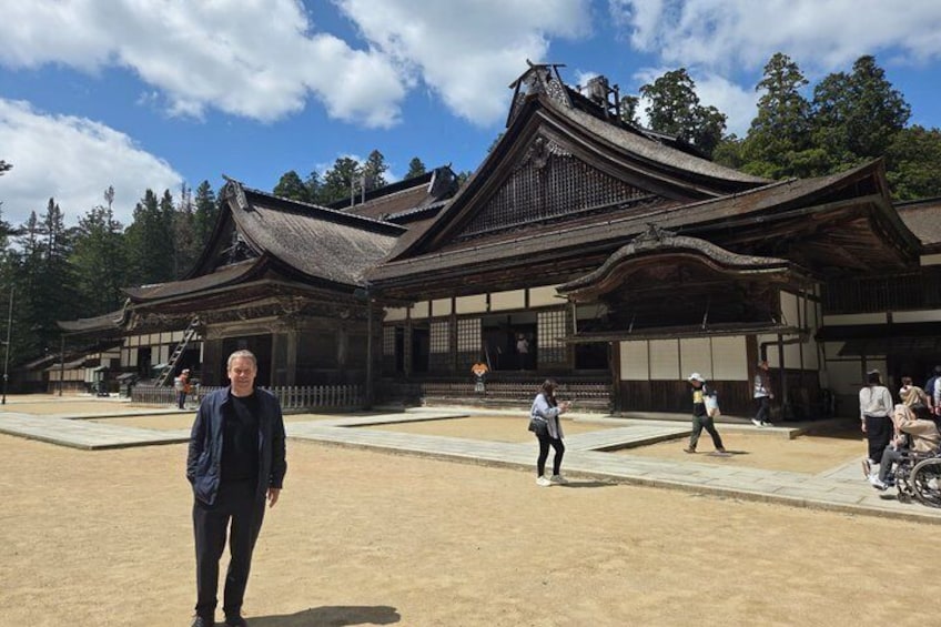 A traditional Japanese building with a tiled roof and wooden structure. 2