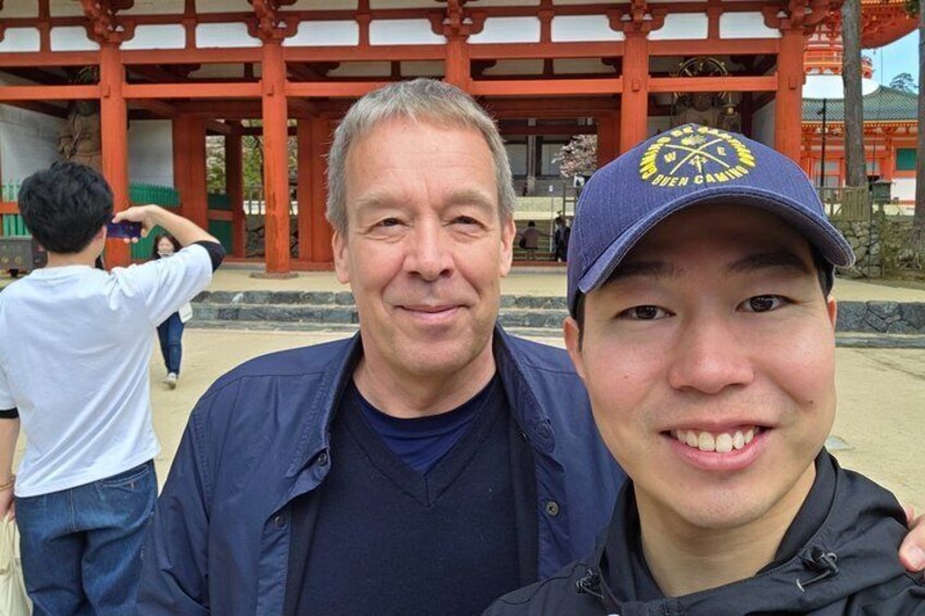 Two people in front of a traditional Japanese torii gate. 5