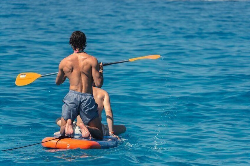 Two people kayaking on a calm sea. 3