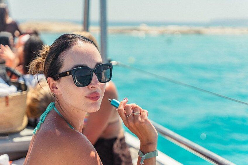 A person on a boat with a clear blue sea in the background. 4