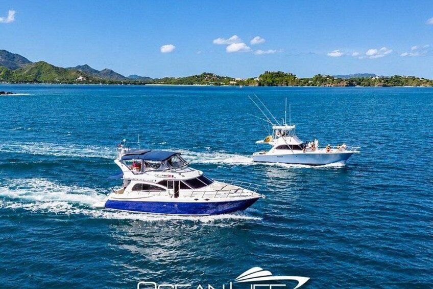 Two boats on a calm sea with a mountainous coastline in the background. 2