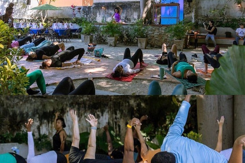 A group of people practicing yoga outdoors. 1