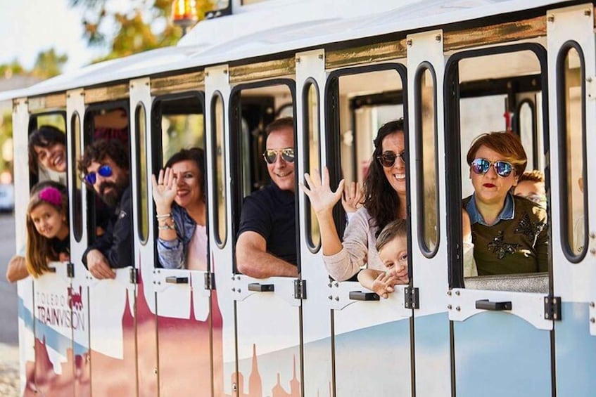 A train with passengers looking out the windows. 1