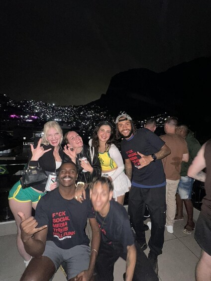 A group of people posing for a photo with a cityscape in the background. 3
