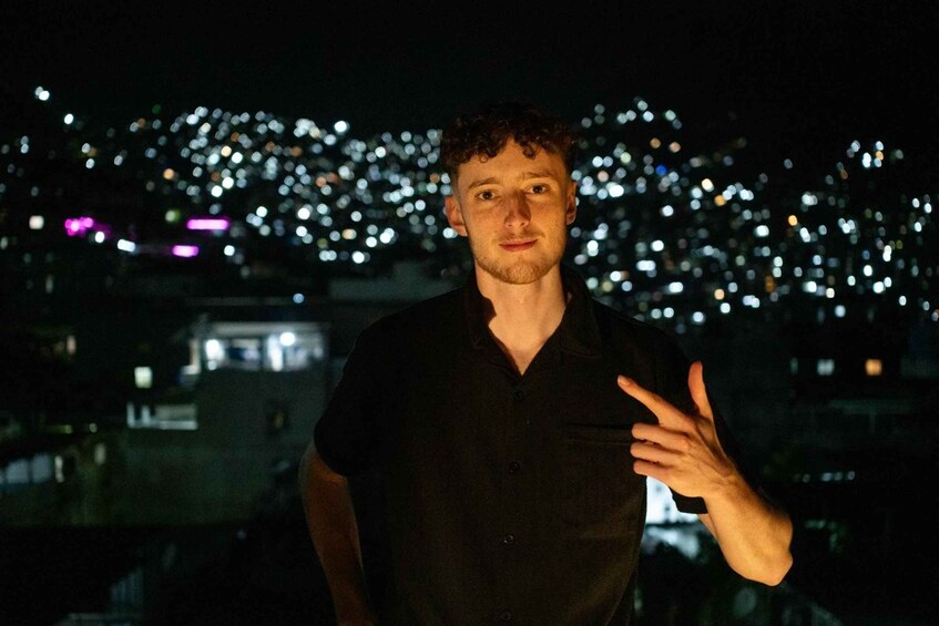 A person standing with a cityscape in the background. 3