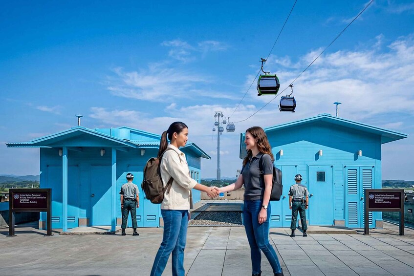 Two people shaking hands in front of a blue building with a sign for the United Nations Conference Building. 4