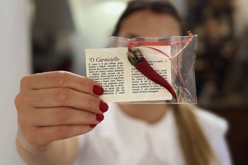 A person holding a small red chili pepper and a piece of paper with text. 4