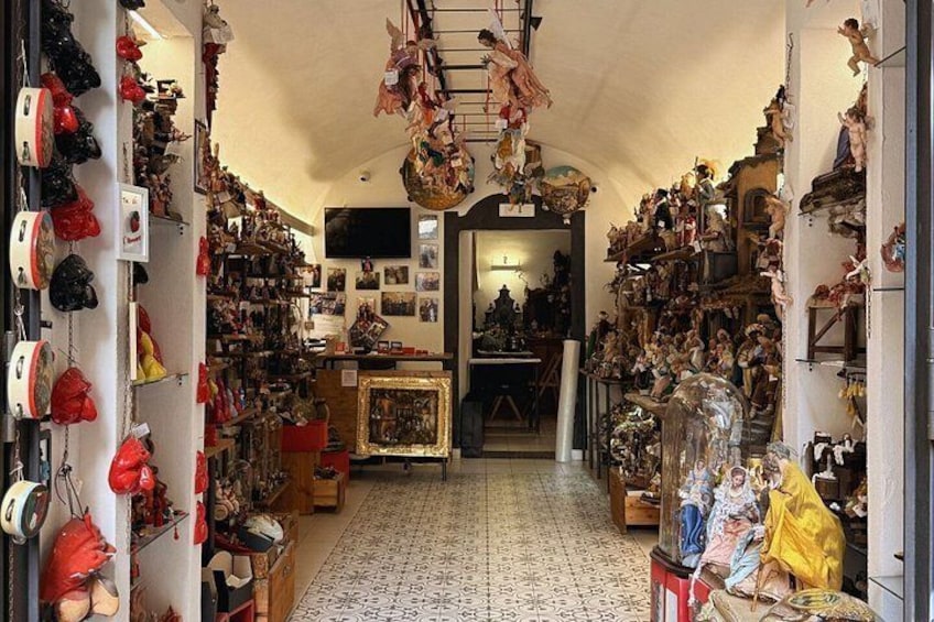 A narrow hallway with shelves filled with various figurines and decorations. 3