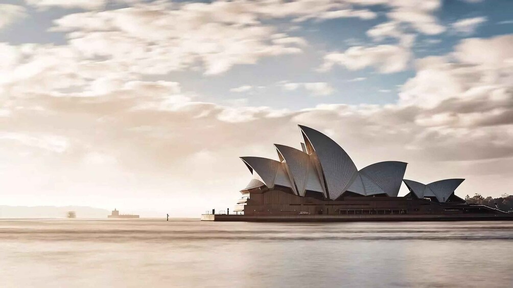 The Sydney Opera House with its distinctive sail-like design, situated by the waterfront. 3