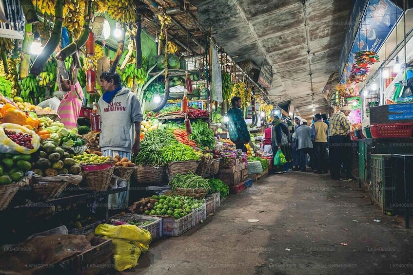A bustling indoor market with various fruits and vegetables on display. 5