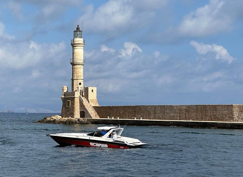 A lighthouse, a stone wall, and a boat on the water. 5