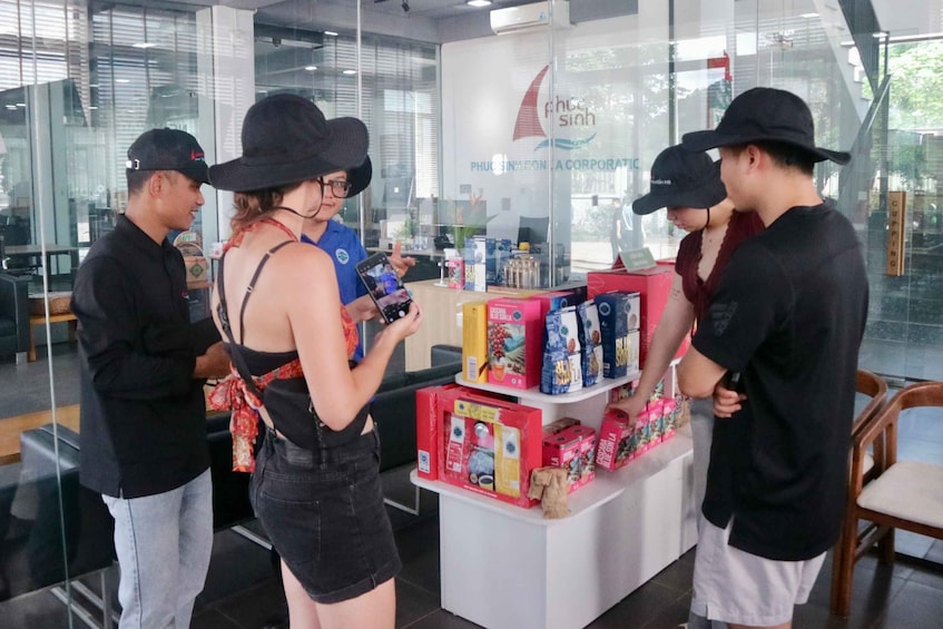 A group of people in a store with shelves of products and a sign that reads 'PHU CHI SING.' 4