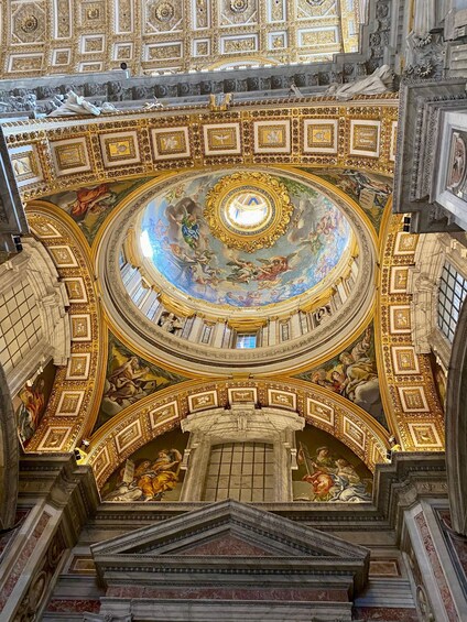 A grandiose interior with a domed ceiling, ornate gold detailing, and classical architecture. 5